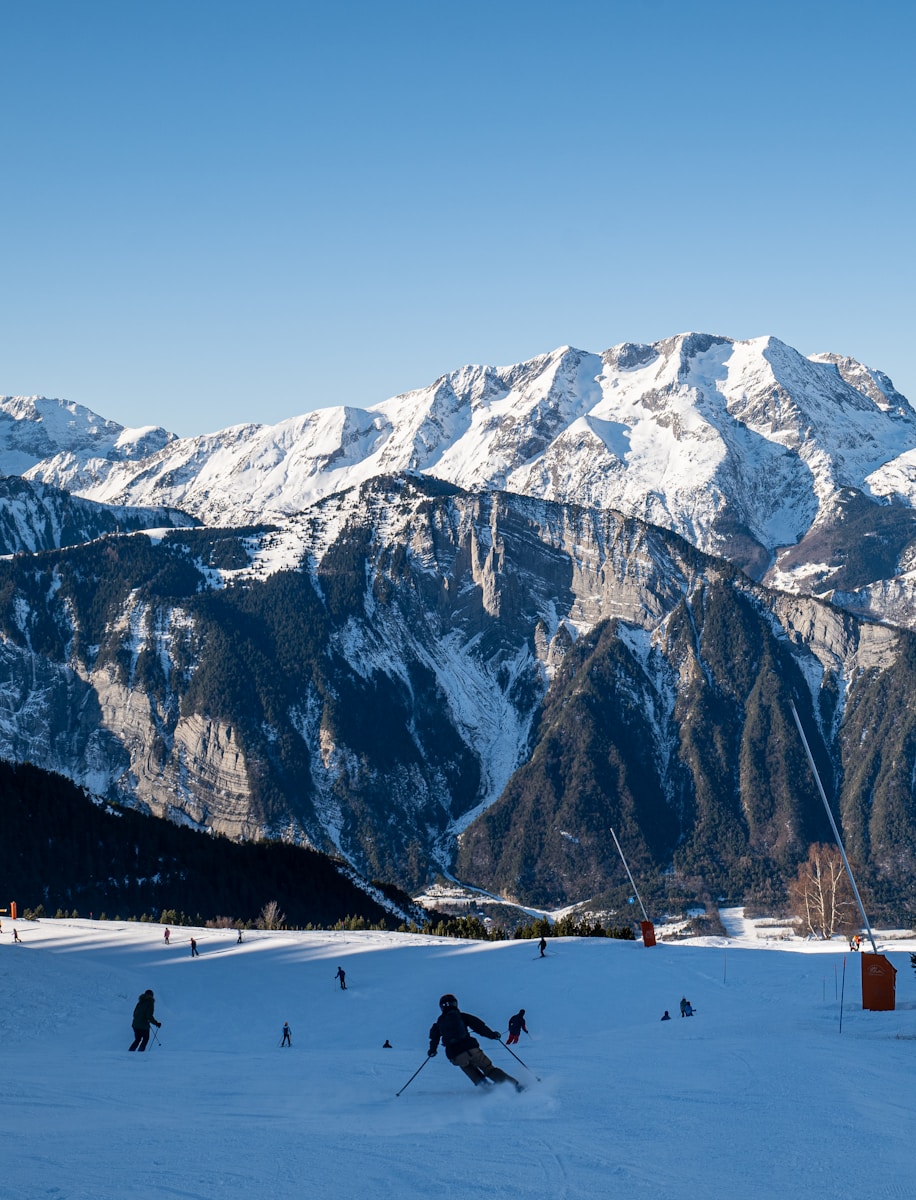 A group of people riding skis on top of a snow covered slope